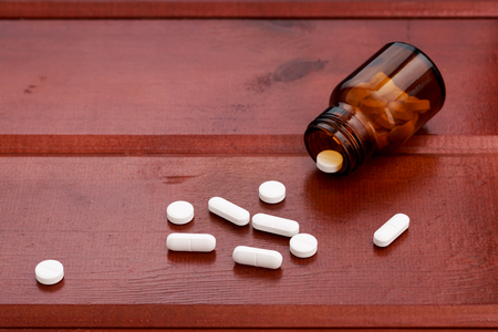 Glass bottle for pills with white tabletsの写真素材