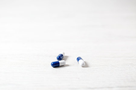 Three blue medicine capsules