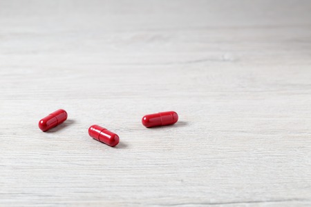 Three red medicine capsulesの写真素材
