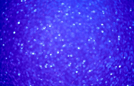 Abstract background filled with blured blue glitter