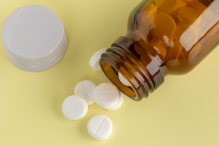 glass bottle of white pillsの写真素材