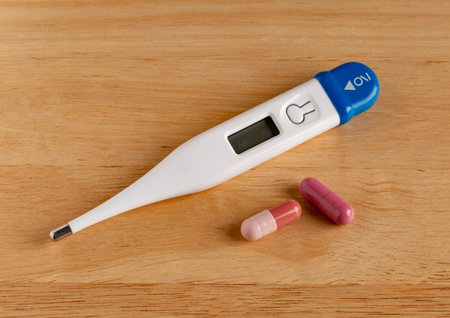 Medical digital thermometer display 38.6 degrees celsius. Traditional medicine vs chemical medicine.