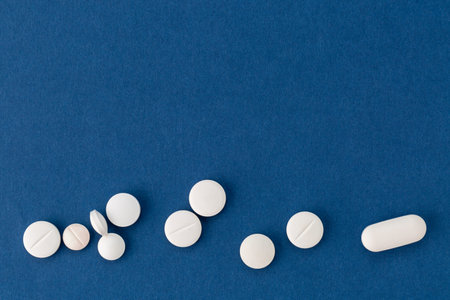 different white pills on blue background