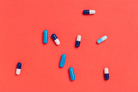 Colorful medicine capsules on a single color backgroundの写真素材