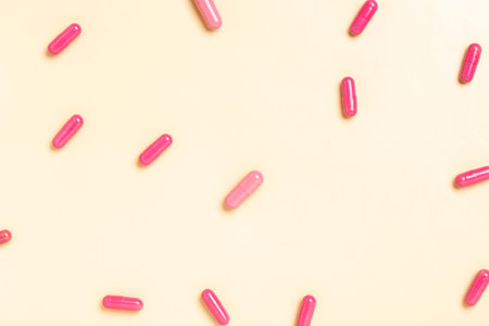 Colorful medicine capsules on a single color backgroundの写真素材