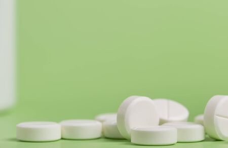 White round medicine pills. Green homogeneous background. At the top of the photo place for a banner.の写真素材