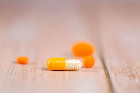 Home therapy. Different orange and yellow pillsの写真素材
