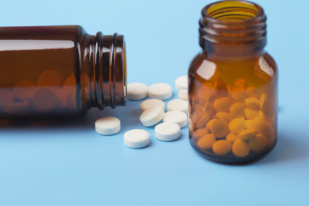 Various medicine. White round pills and two pill bottleの写真素材