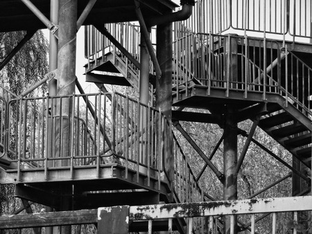 Black and white photo of metal stairs at the crossing roadの写真素材
