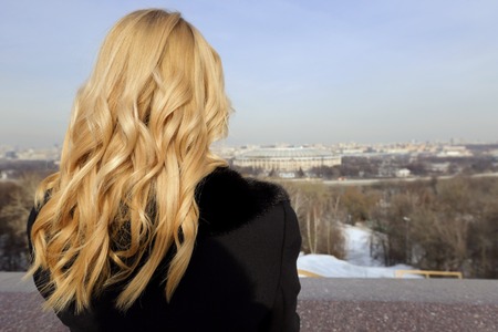 The blonde girl on the observation deck in Moscow in winterの写真素材