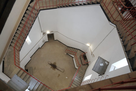 Staircase inside the clock tower with white walls