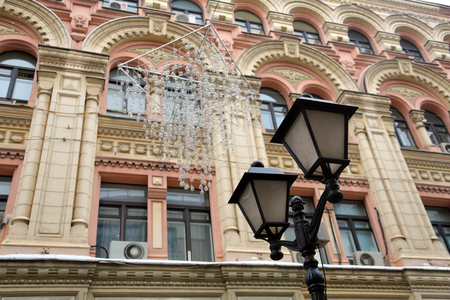 Vintage black lantern on a city streetの写真素材