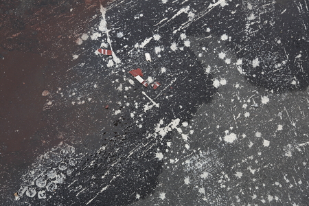 Blots and stains of white paint on ruberoidの写真素材