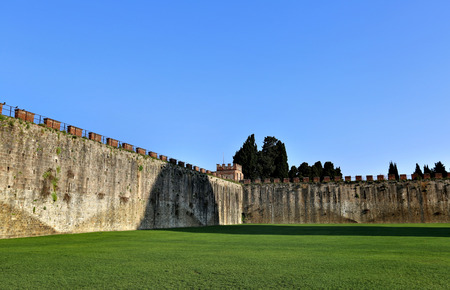The courtyard of the old stone fortress with a green lawnの写真素材