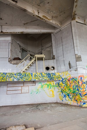 Inside an abandoned deserted cluttered industrial buildingの写真素材