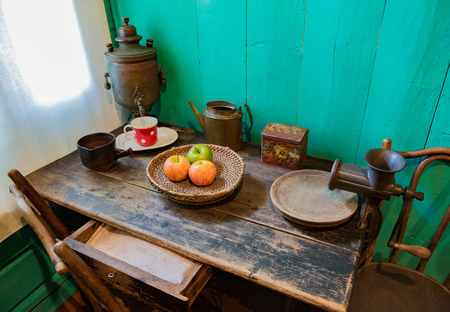 Vintage set for tea, apples and meat grinder on an old wooden tableの写真素材