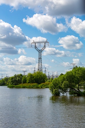 Huge metal racks of high voltage power lines in the cityscapeの写真素材