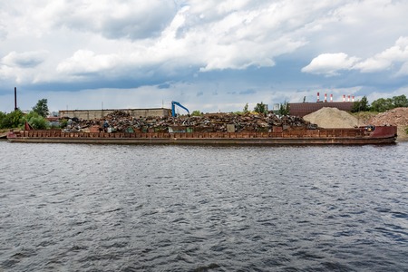Dump of metal rusty waste on the shore of the reservoirの写真素材