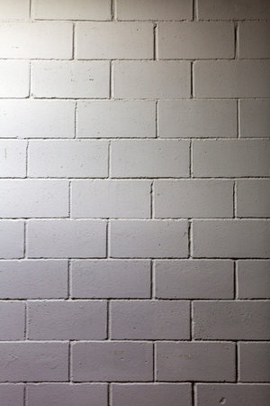 Textured surface of the gray painted brick wall