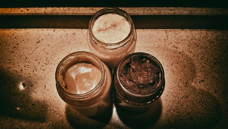 Spicy mustard, wiped horseradish and Caucasian ketchup in glass jarsの写真素材