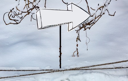 Street direction pointer without signs and symbols in the snowの写真素材