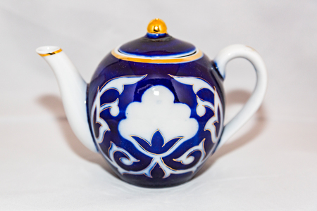Colored ceramic tea kettle with a handle and spoutの写真素材