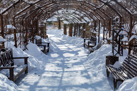 Trampled path for walking pedestrians in a snowbound winter city parkの写真素材
