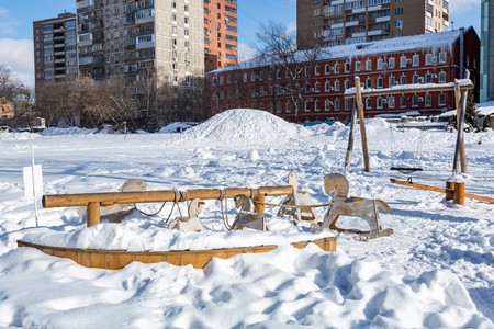 Snow-covered children's playground in public park in winterの写真素材
