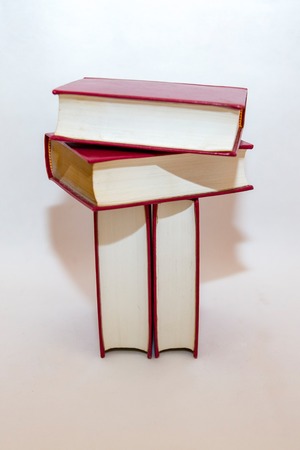 Stack of small books in hard cover on a white backgroundの写真素材