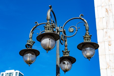 Vintage iron lantern on a city street on a sunny dayの写真素材