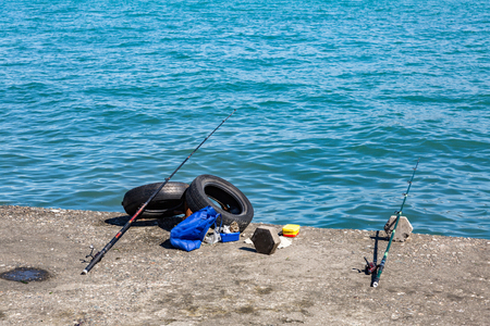 Spinnings for fishing near the blue sea waterの写真素材
