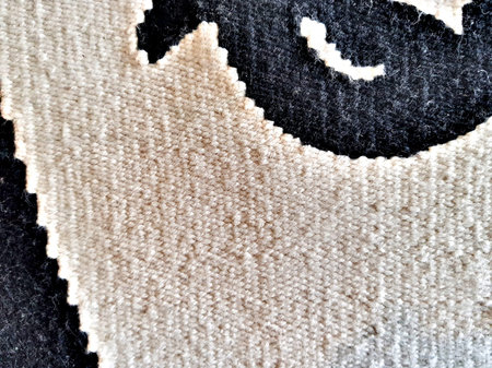 Natural wool carpet with handmade patterns. Texture
