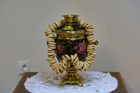 A device for boiling water and making tea. Traditional Russian samovar with dried ring-shaped rollsの写真素材