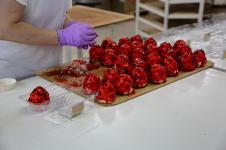 Freshly baked confection in bread and sweets factoryの写真素材