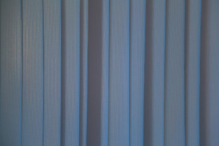 Textured surface of colored vertical textile blinds