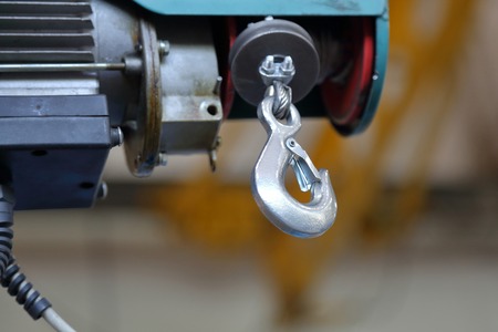 Massive industrial hook for lifting and moving parts in the repair shopの写真素材