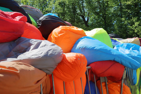 Chaotically heaped soft multi colored armchairs-bags in a city parkの写真素材