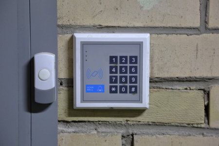 Modern electric door bell on the inner wall of the building