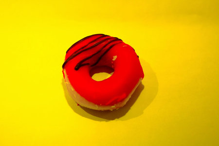 Freshly baked sweet donut on a plain background with shadowsの写真素材