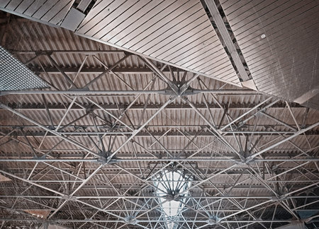 The construction of the steel beams and metal pipes on the ceiling
