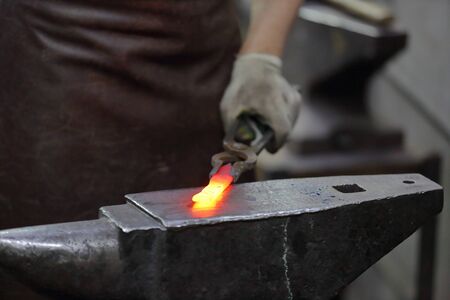 Forging an iron handmade product in a craft forge workshopの写真素材