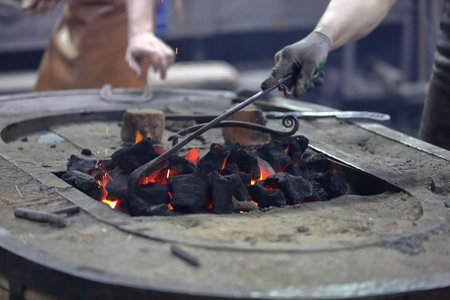 Hot coals in a furnace for heating metal for manual forging in a blacksmith workshop