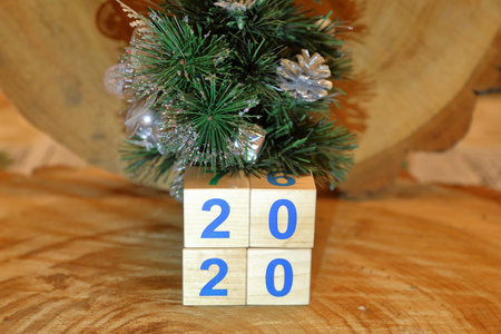 Wooden cubes with digits 2020 on a natural wood background