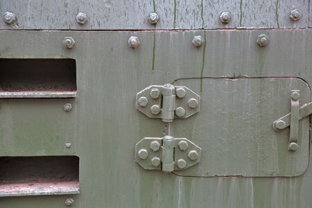 Green textured surface of armored metal with roughness and scratchesの写真素材