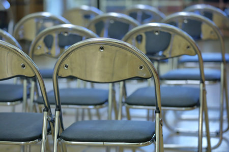 Rows of comfortable aluminum chairs stand in the lecture hall