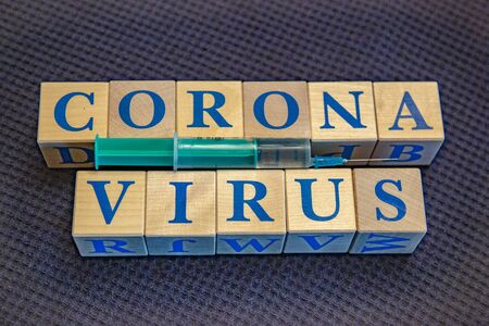 Wooden cubes with word Coronavirus in blue lettersの写真素材