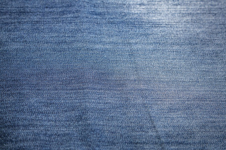 Blue textured surface of a thick cotton denim fabric