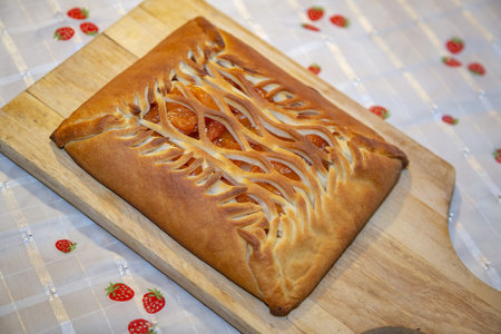 Delicious homemade pastry pie with dried apricots inside