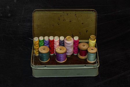 Vintage set of threads for sewing and crafts in an old metal box