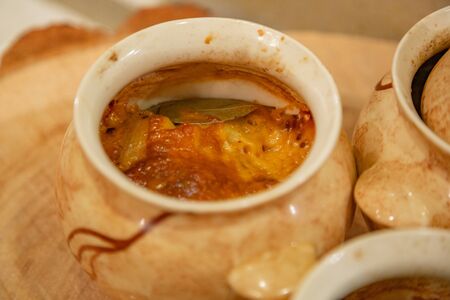 Recipe for baked meat with cheese and fresh vegetables in earthenware potsの写真素材